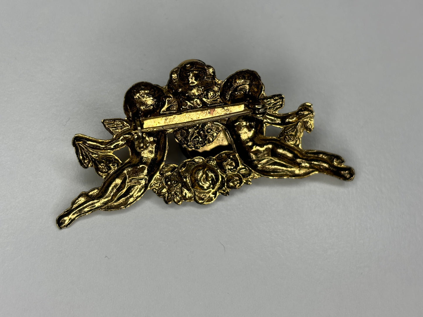 Gold Tone and Black Cherub Brooch