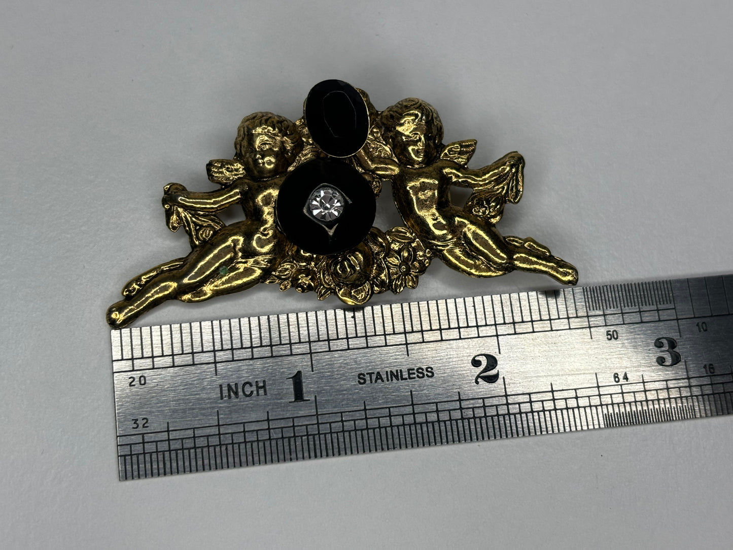 Gold Tone and Black Cherub Brooch